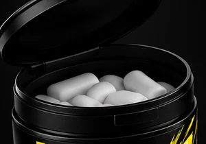Open SLAP GUM tub full of white hard-shell gum pieces